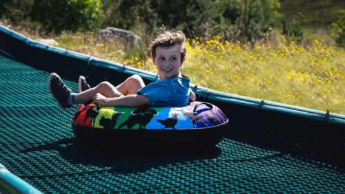 Boy on tubing slide