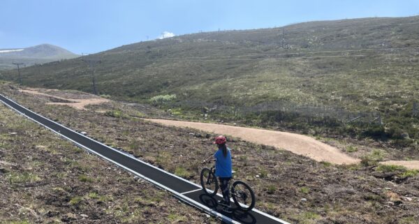 Mountain biker on conveyor belt.