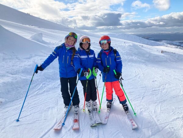 Three girls skiing