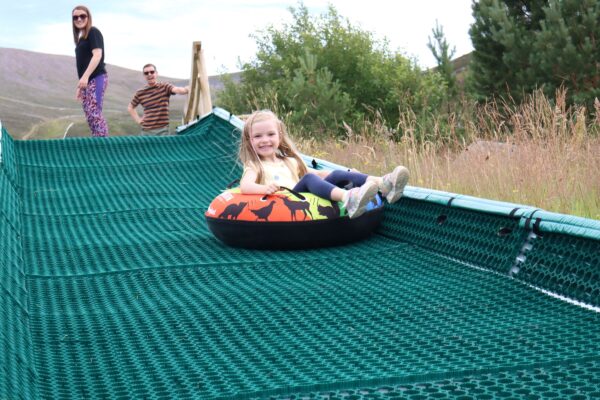 Young girl on snowflake slide at Cairngorm Mountain