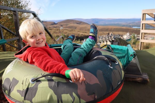 Young boy on tubing slide