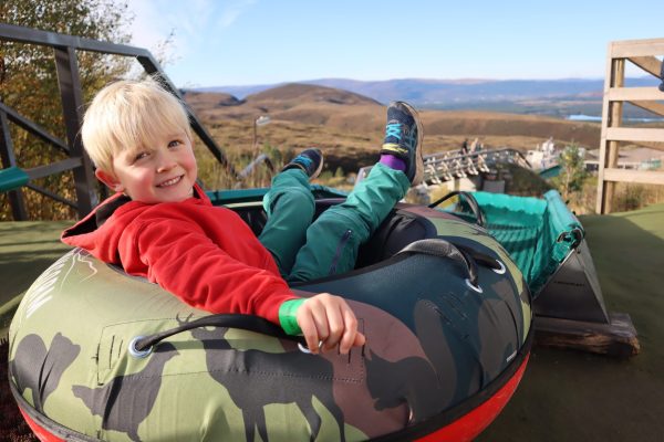 Young boy on tubing slide