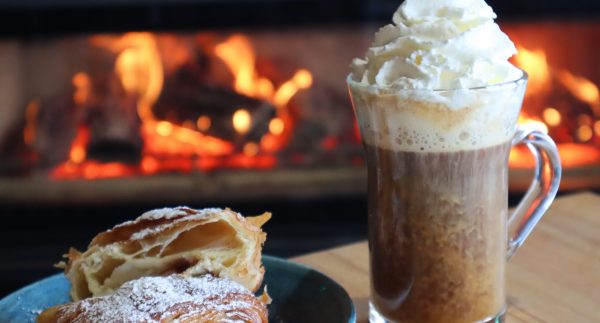 Coffee and cake in front of a log fire