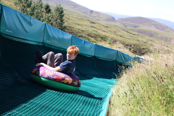 Cairngorm Mountain staff member on tubing slide