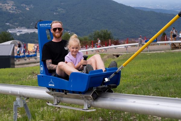 Adult and child on toboggan ride